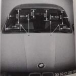 Photo of a BMW E30 windshield marked with the washer jet aiming distances 258, 405, 460, 265, 310, 473, 490 and 285 mm