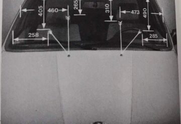 Photo of a BMW E30 windshield marked with the washer jet aiming distances 258, 405, 460, 265, 310, 473, 490 and 285 mm