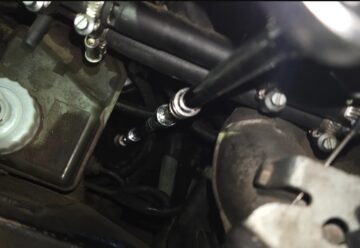Swivel socket on an extension reaching the E30 control arm center ball joint nut from the top